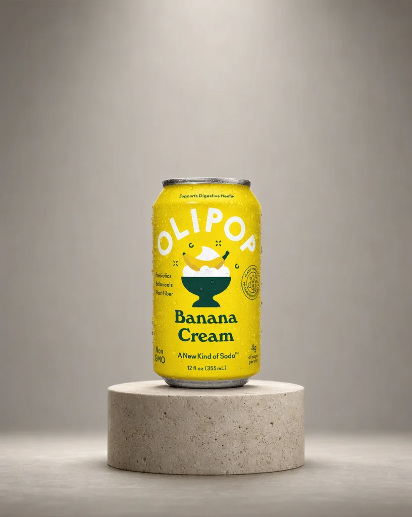 The OLIPOP can on a round travertine plinth against a grey gradient backdrop